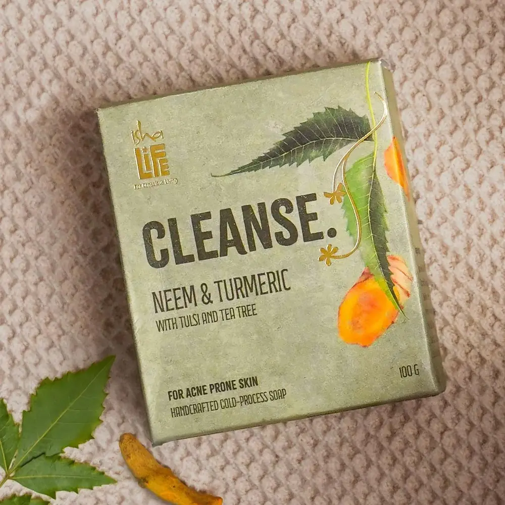 Neem and Turmeric soap box on a woven cloth with neem leaves