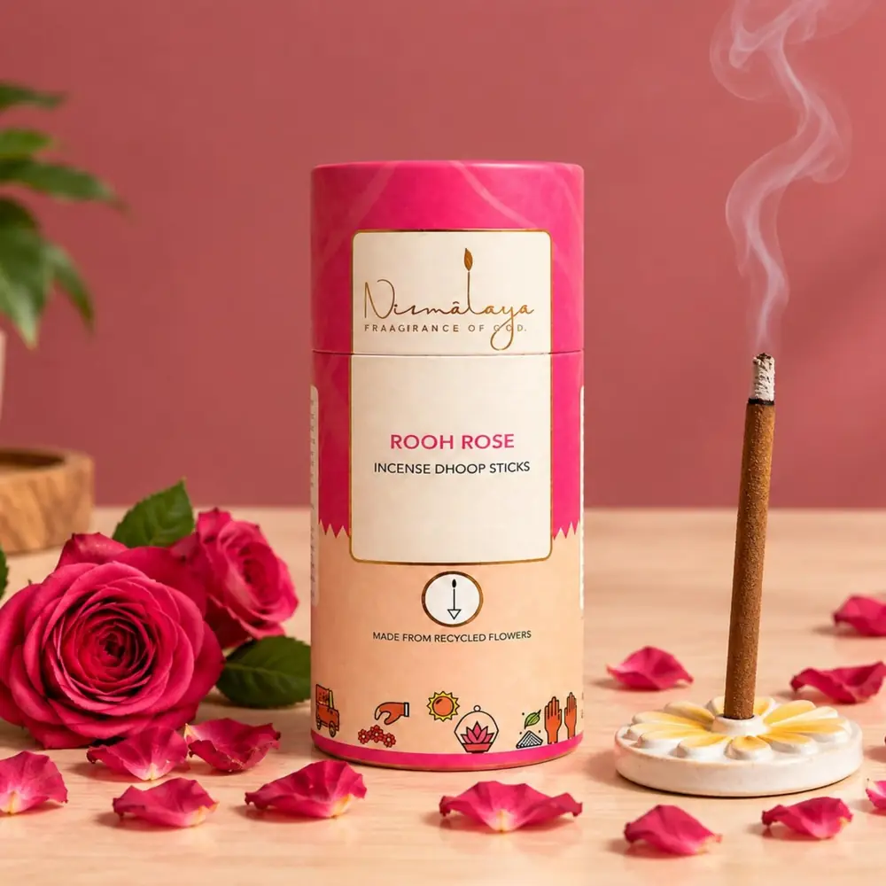 The pink Rooh Rose tube with roses and a lit stick