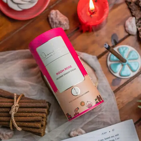 The tube with a bundle of dhoop sticks and rose petals