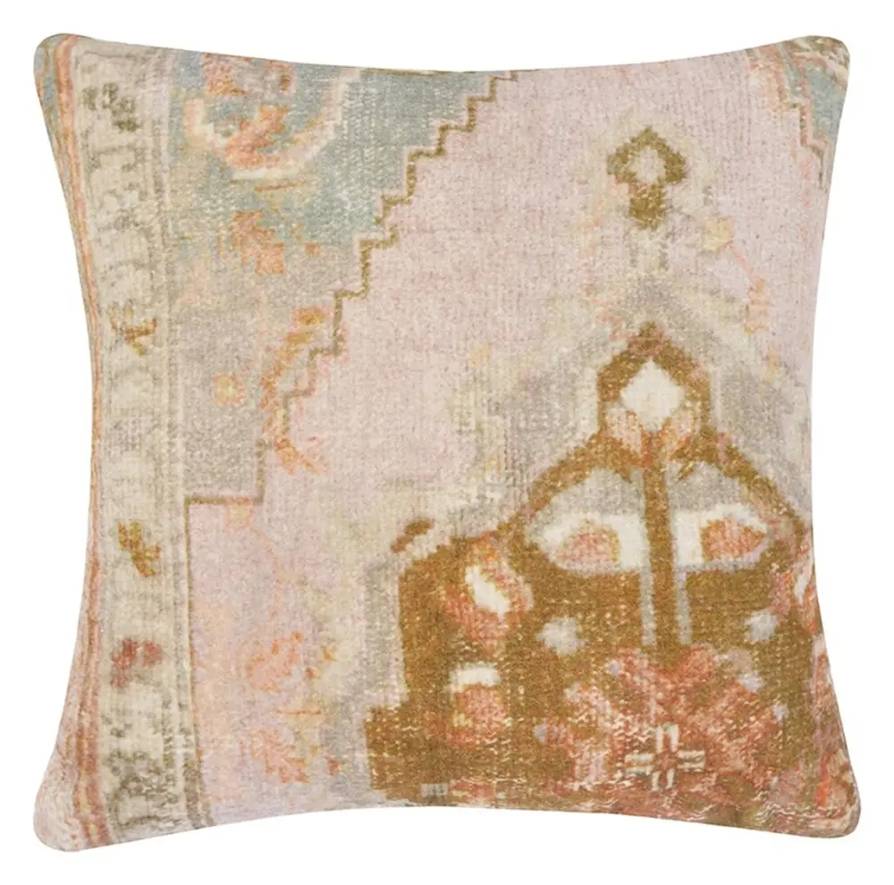 Cushion cover with a rug style print in muted pink and olive