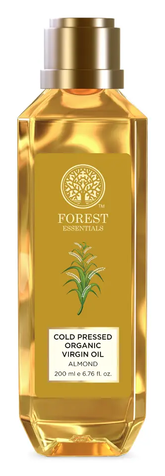 Bottle of cold pressed almond oil on white