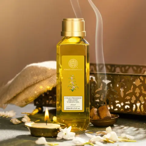 The bottle beside lit lamps and a cloth in a styled shot