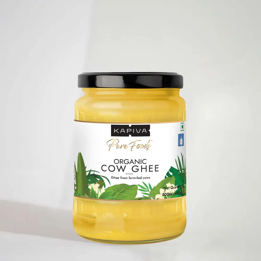 Jar of organic cow ghee with a black lid on a grey ground