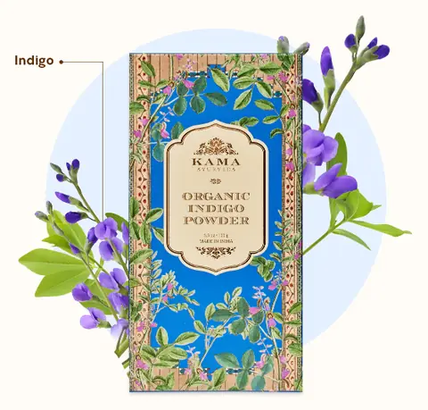 Blue carton beside indigo flowers and leaves