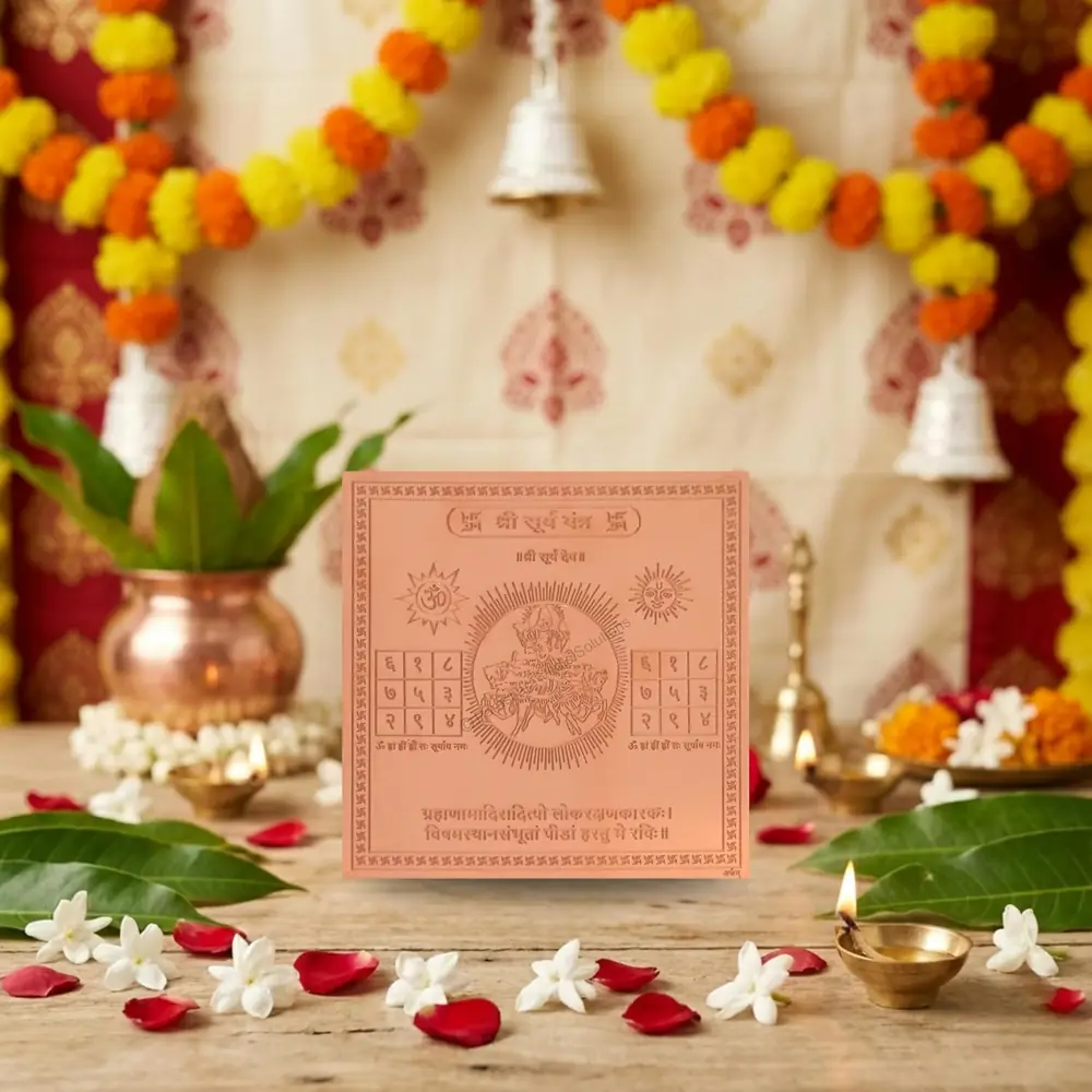 The yantra on a puja table with a copper pot and flowers