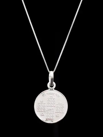 The pendant on a chain showing the other face