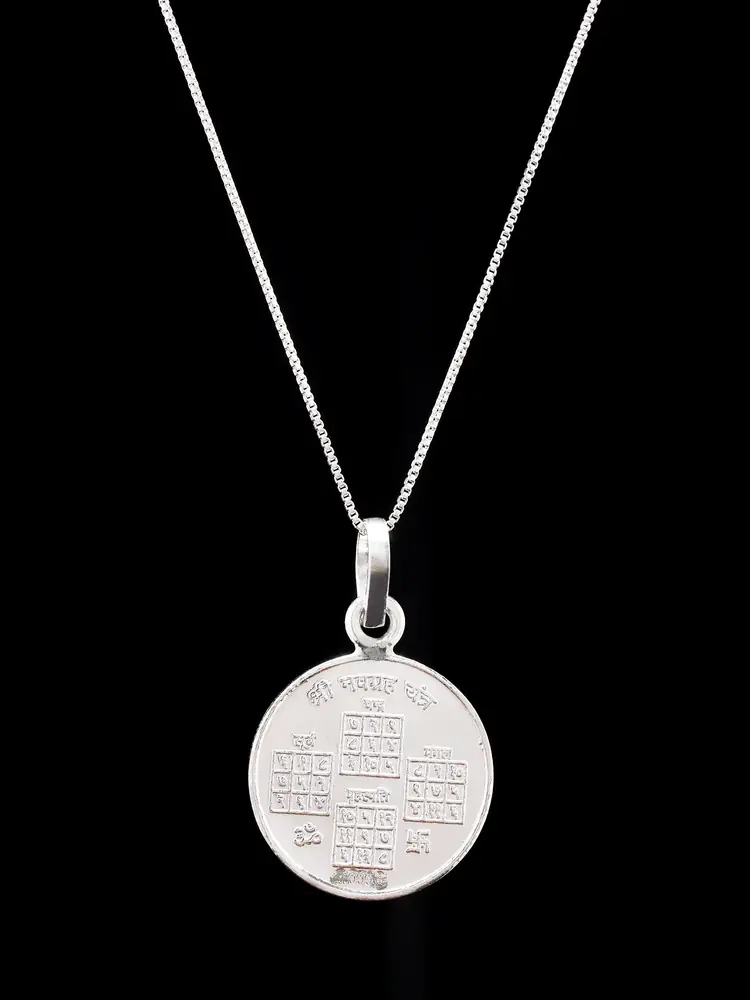 The pendant on a chain showing the other face