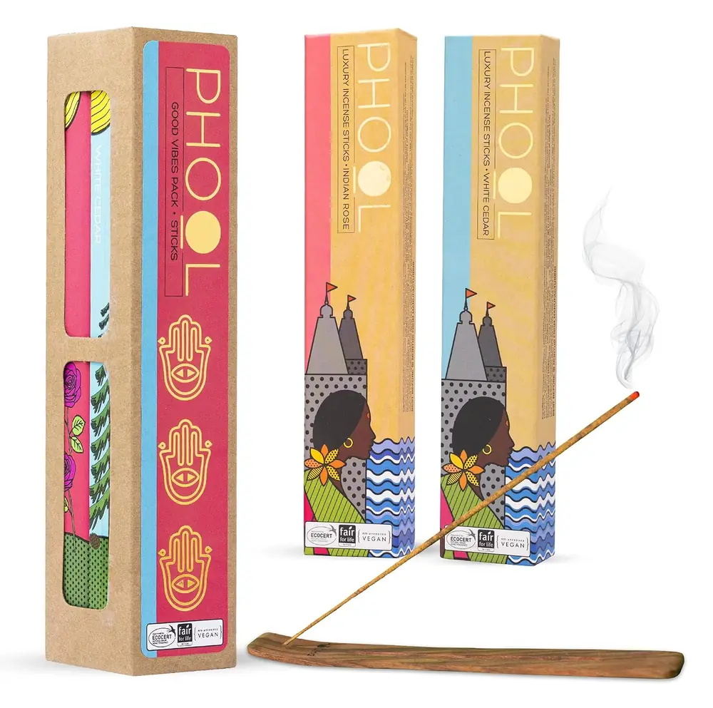 The two Phool boxes with a stick burning on a stand