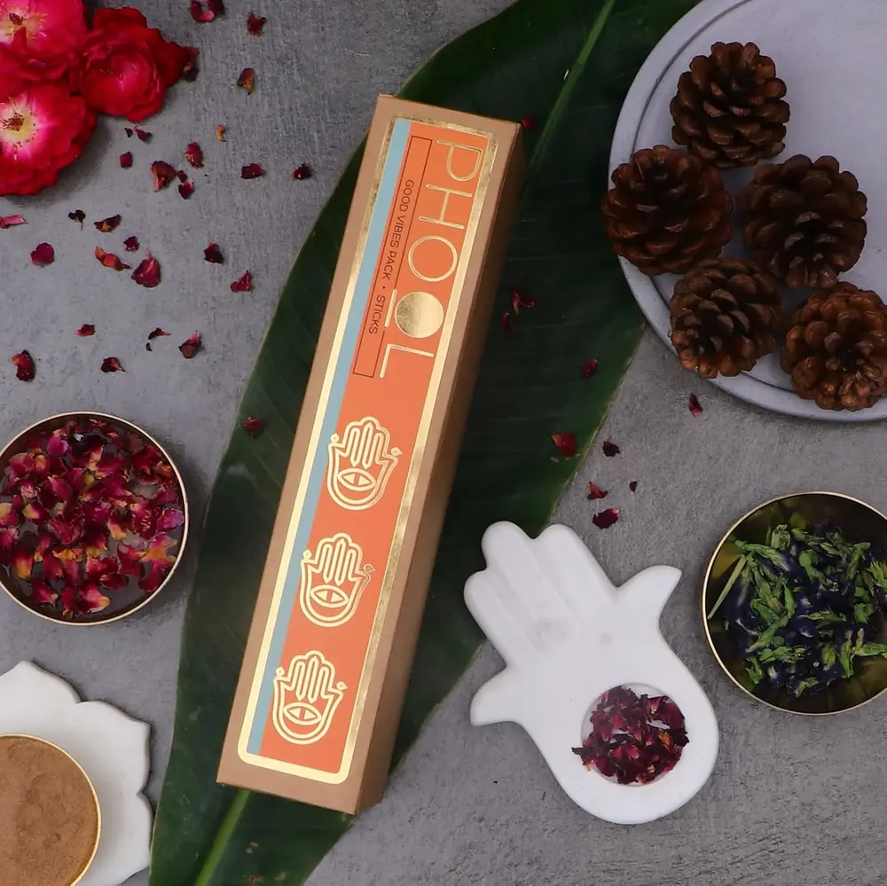 A box on a leaf with pine cones
