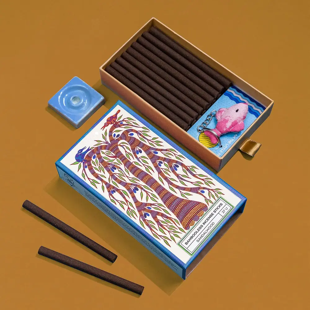 The open box with sticks and a blue stand