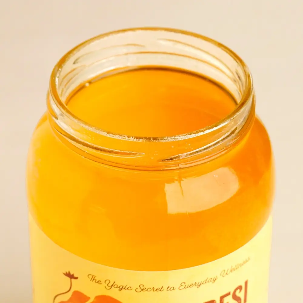 Jar with the lid open, the ghee inside
