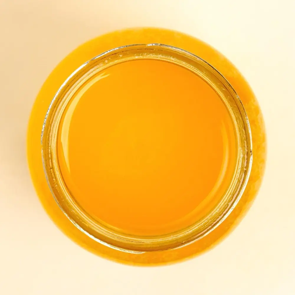 Jar with the lid open, the ghee inside