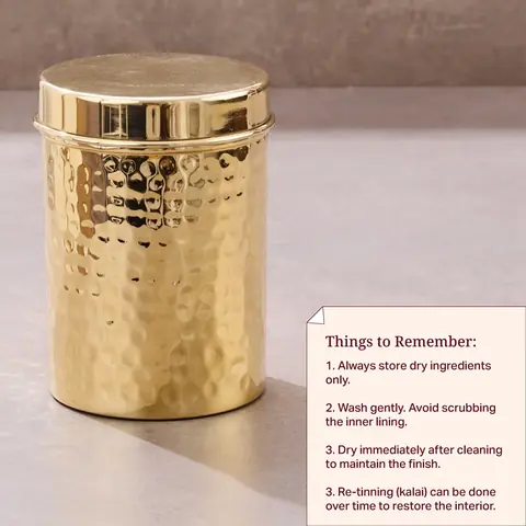 Brass canister with the lid resting on top