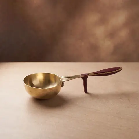 The tadka pan on a warm brown ground