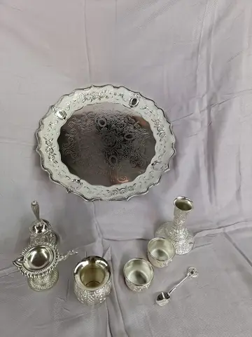 The tray with ornate rim and small pieces on it