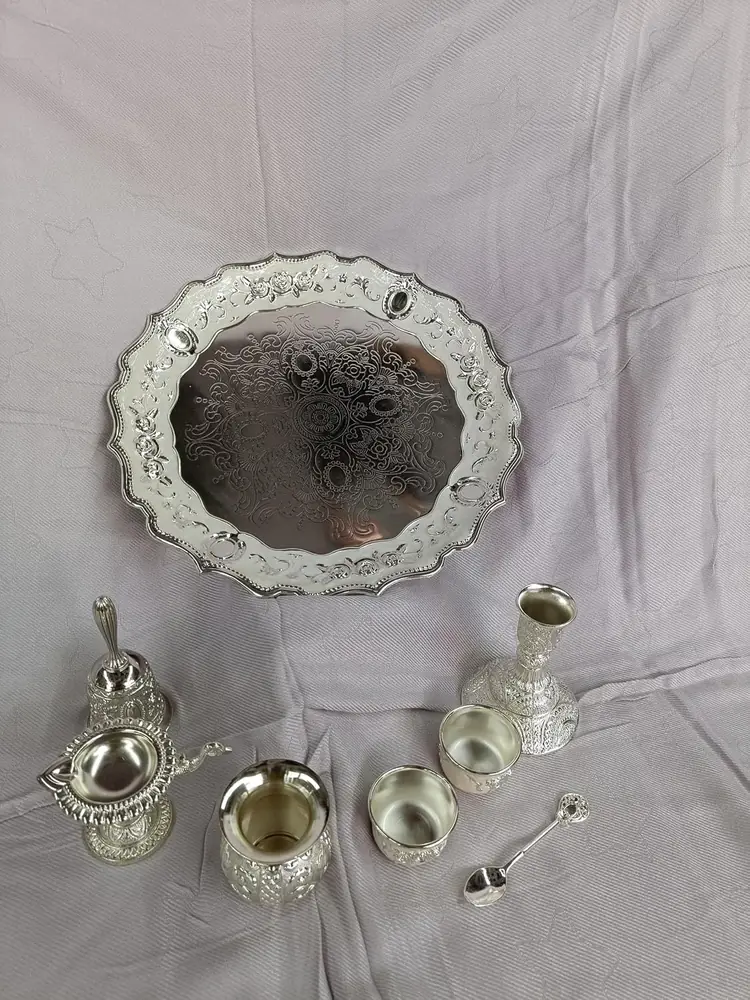 The tray with ornate rim and small pieces on it