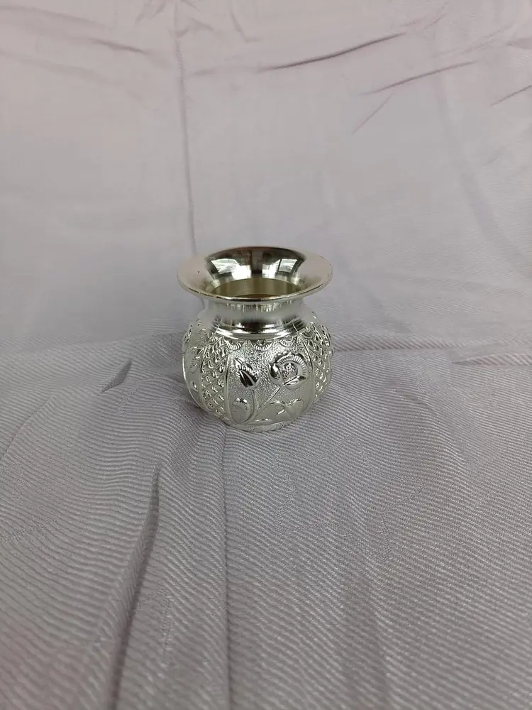 A single silver coloured vessel with a patterned surface