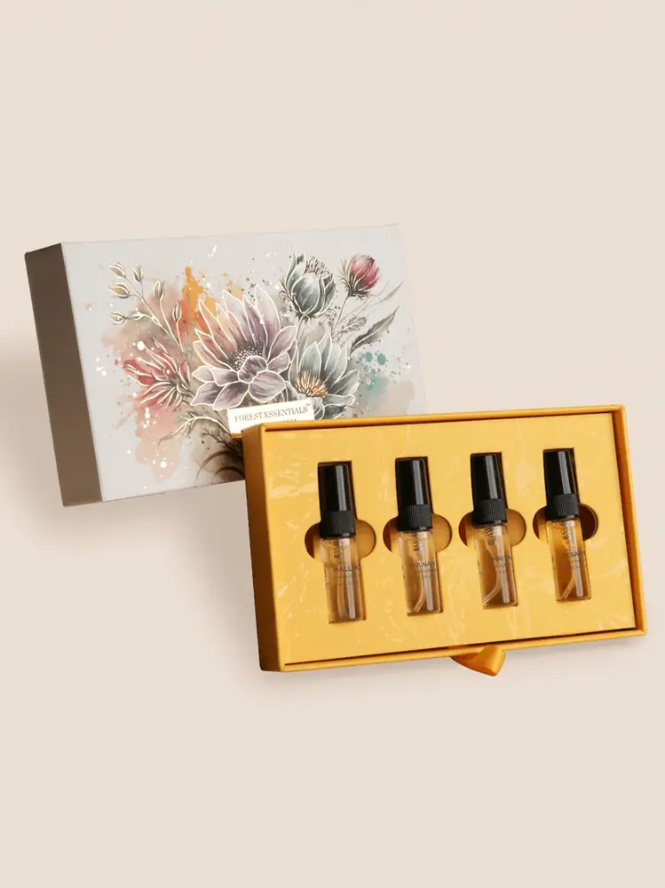 Pushpa gift box with four small perfume bottles in a gold tray