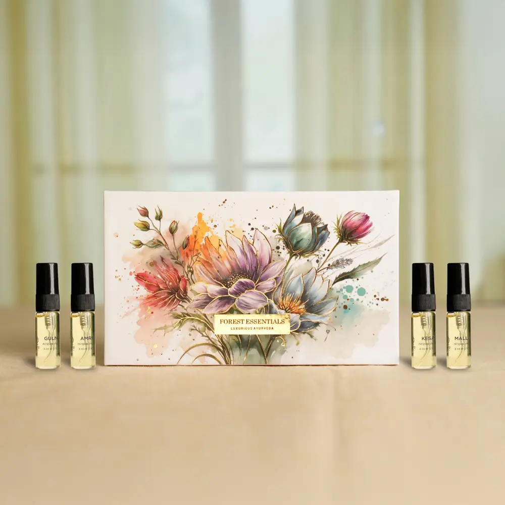Floral gift box beside two perfume bottles