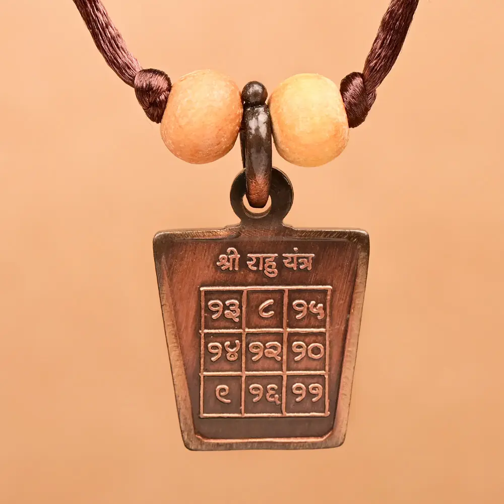 Rahu yantra side of the copper locket on a thread