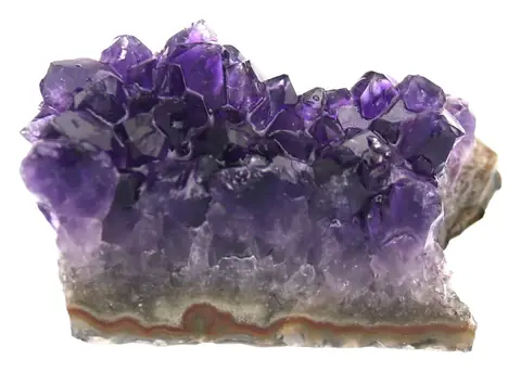 Another view of a raw amethyst cluster on a rock base