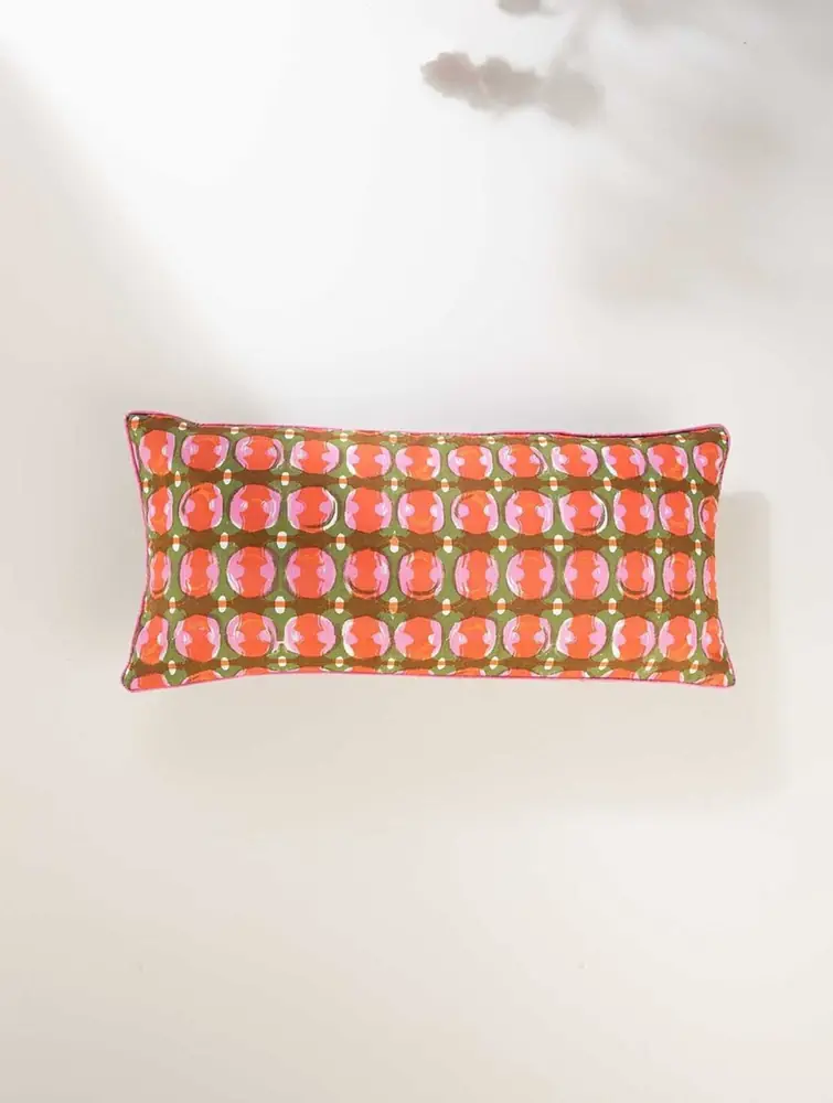 Oblong cover in orange red and pink with a dotted print