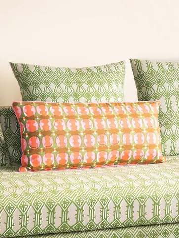 The cover in a styled room with other cushions