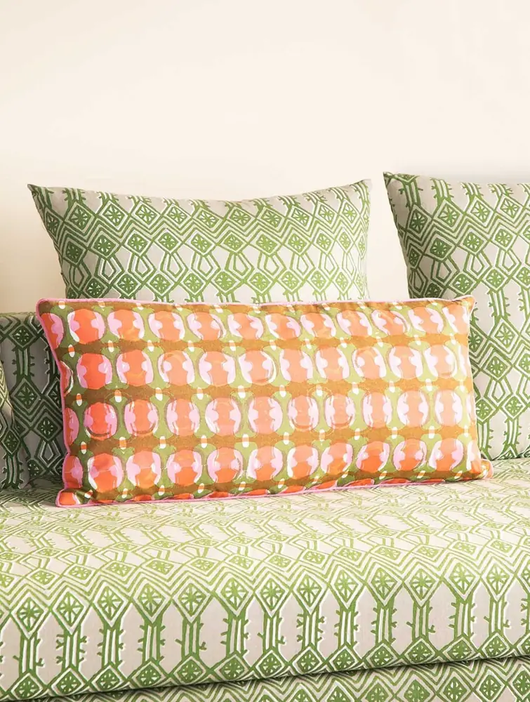 The cover in a styled room with other cushions