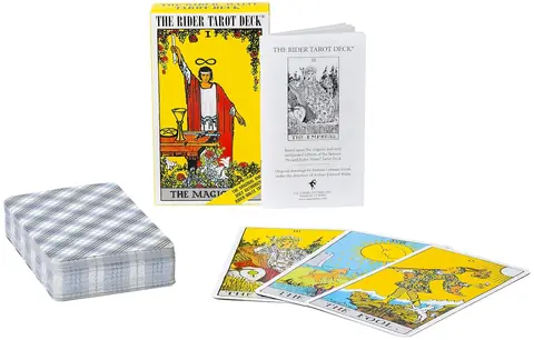 Deck of cards laid out beside the box and booklet