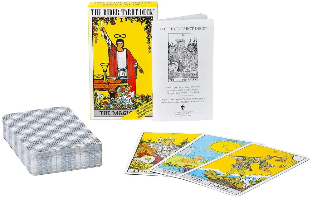 Deck of cards laid out beside the box and booklet