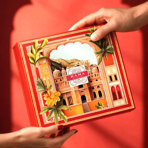 Hands holding the closed red gift box