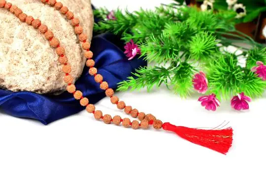 The mala with a red tassel on dark blue cloth