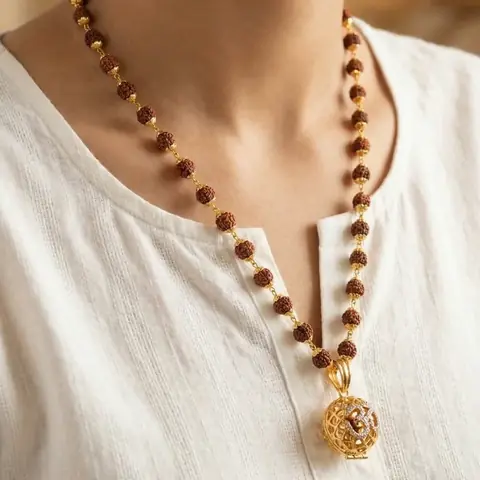 The mala worn over a white shirt