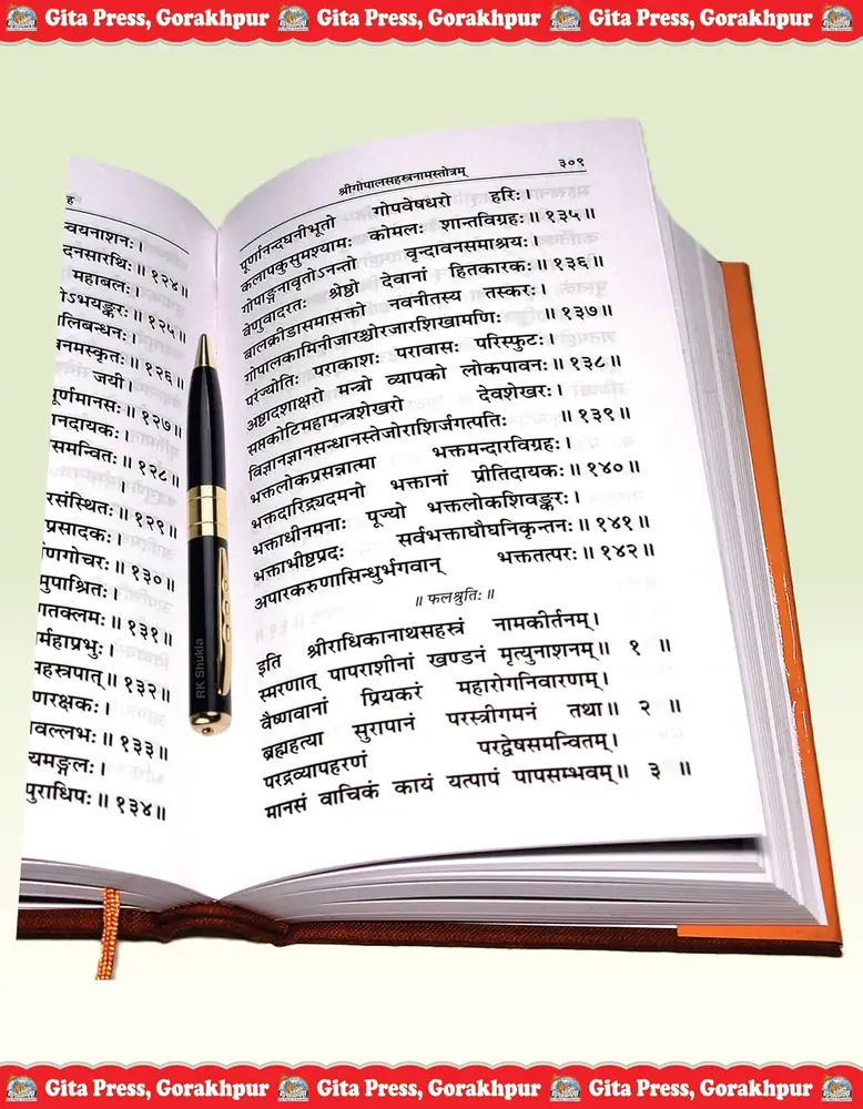 An open page of Sanskrit verse with a pen