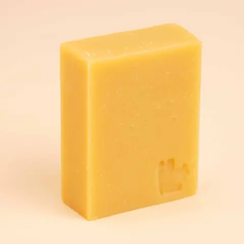 The golden-yellow soap bar on its own
