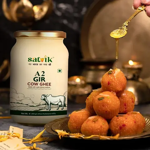 Jar of ghee with a plate of laddus