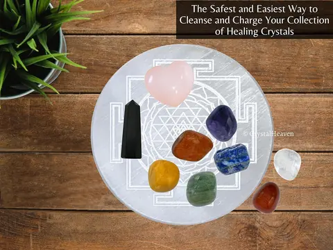 Tumbled stones resting on the selenite plate on a wooden table