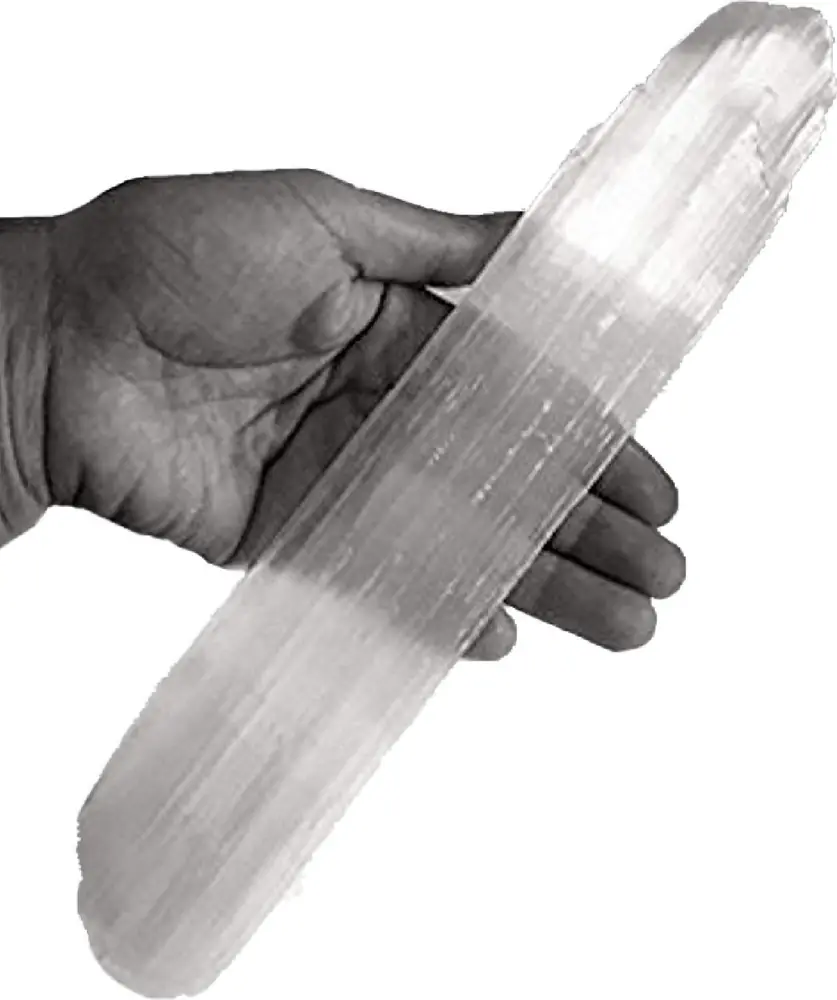 Selenite stick held in a hand, in black and white