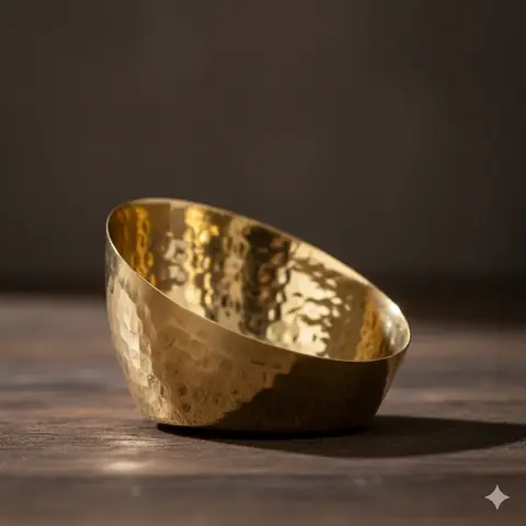 Brass holder with a lit tea light on a dark ground