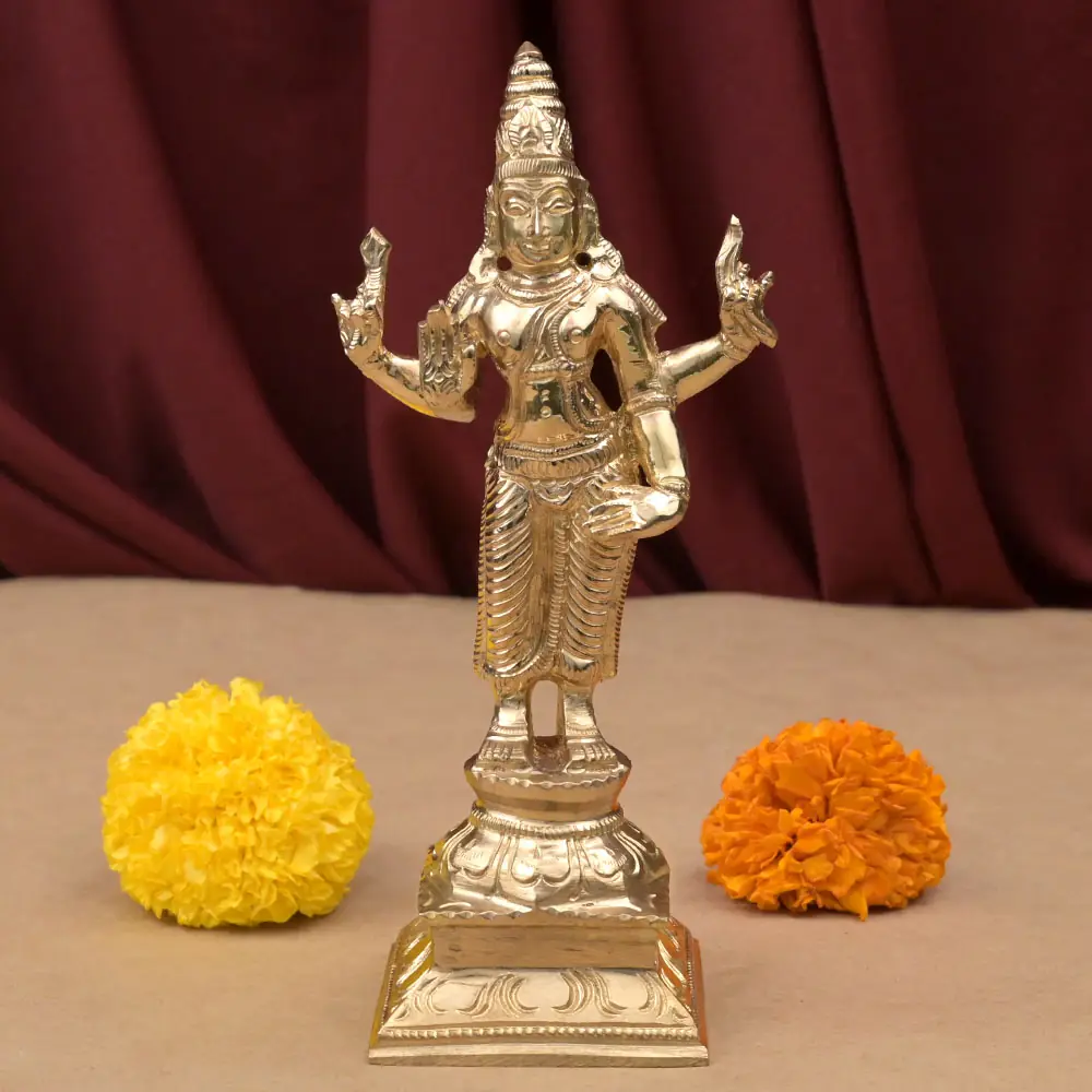 Shani bronze idol standing on its dais with marigolds