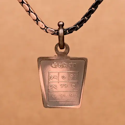 The yantra side on a dark chain