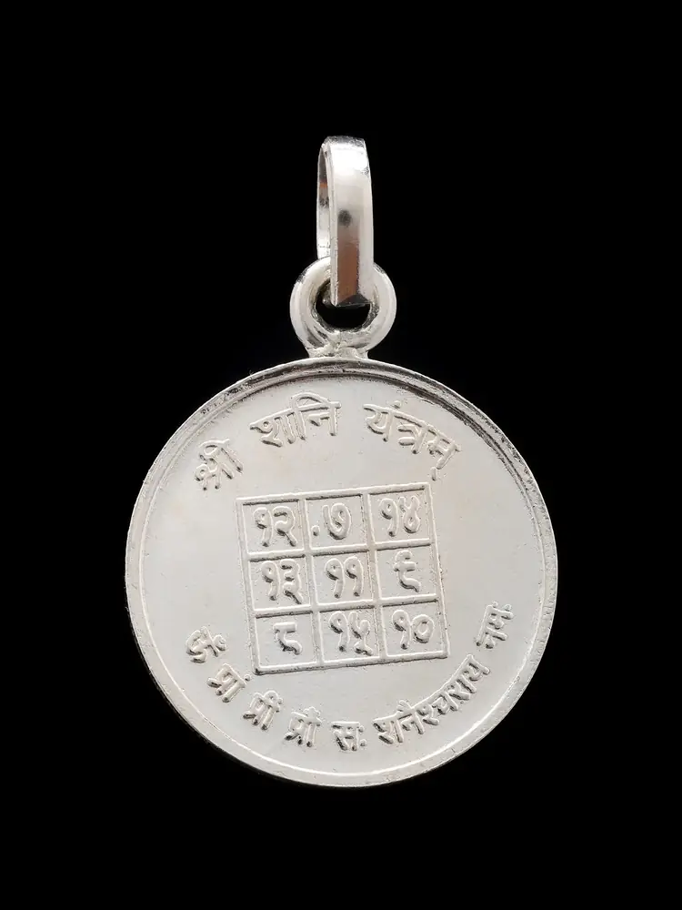 The reverse of the pendant with the number grid yantra
