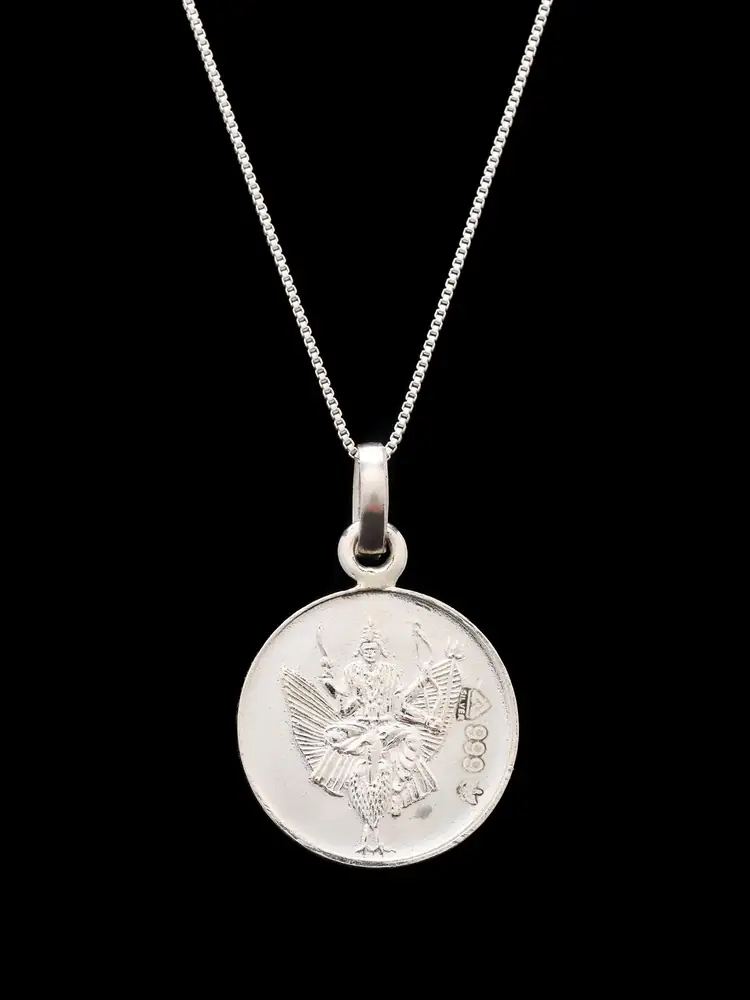 The pendant hanging on a thin chain, figure face