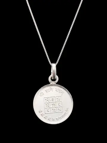 The pendant on a chain showing the yantra face