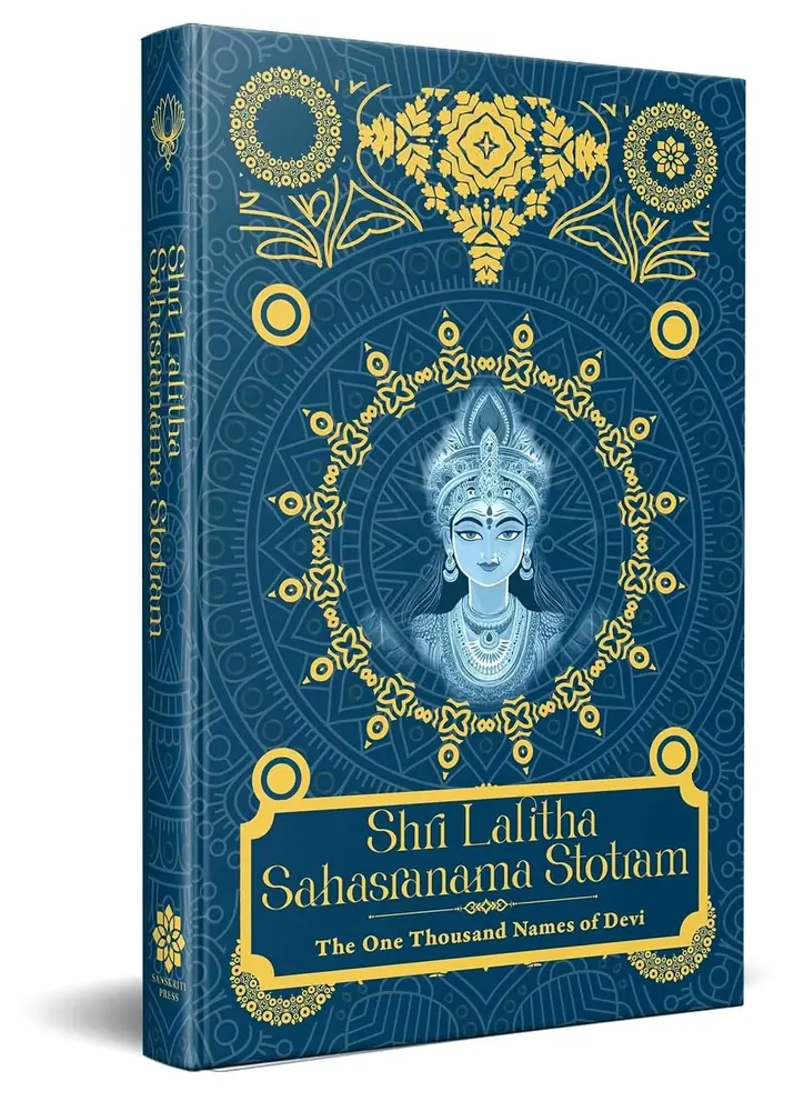 Navy hardbound Lalita Sahasranama beside flowers and a lamp