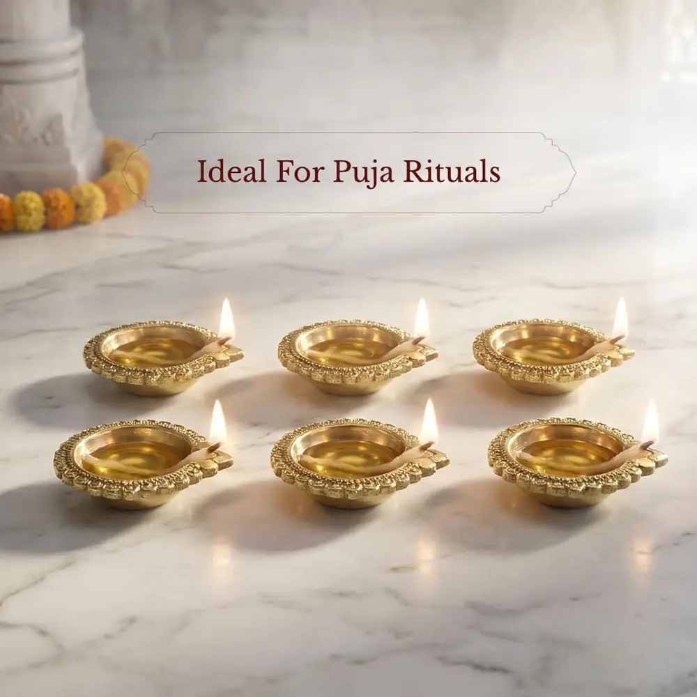Brass diyas arranged on a marble surface