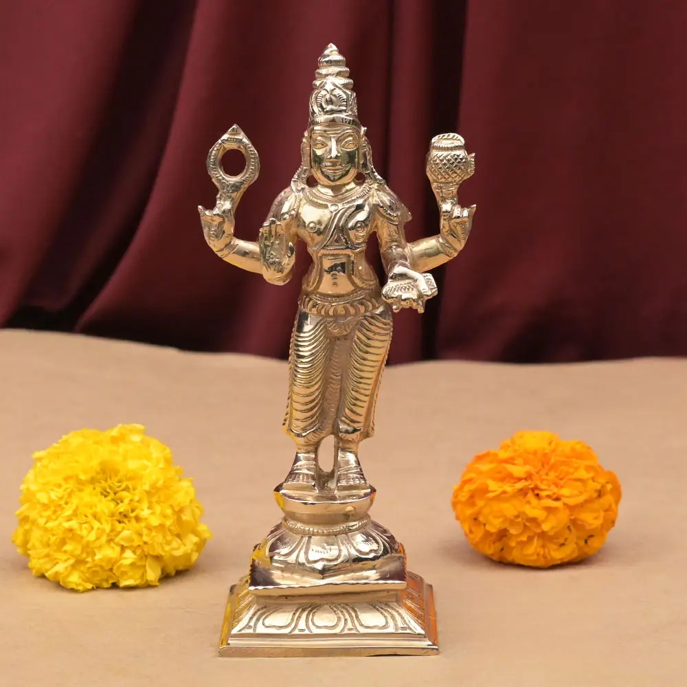 Shukra bronze idol standing on its dais with marigolds