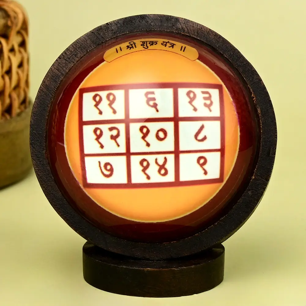 Shukra yantra grid in a round wooden frame on a stand