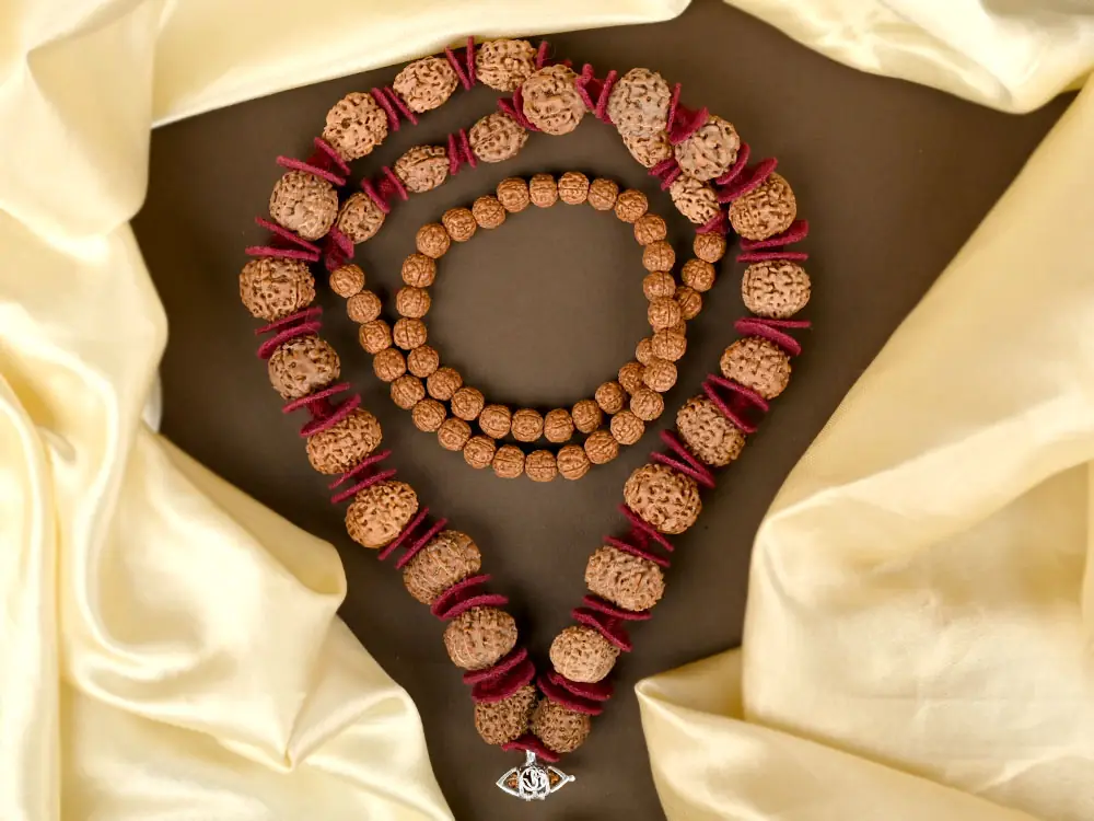 Siddha mala laid on cream and brown cloth with red spacers