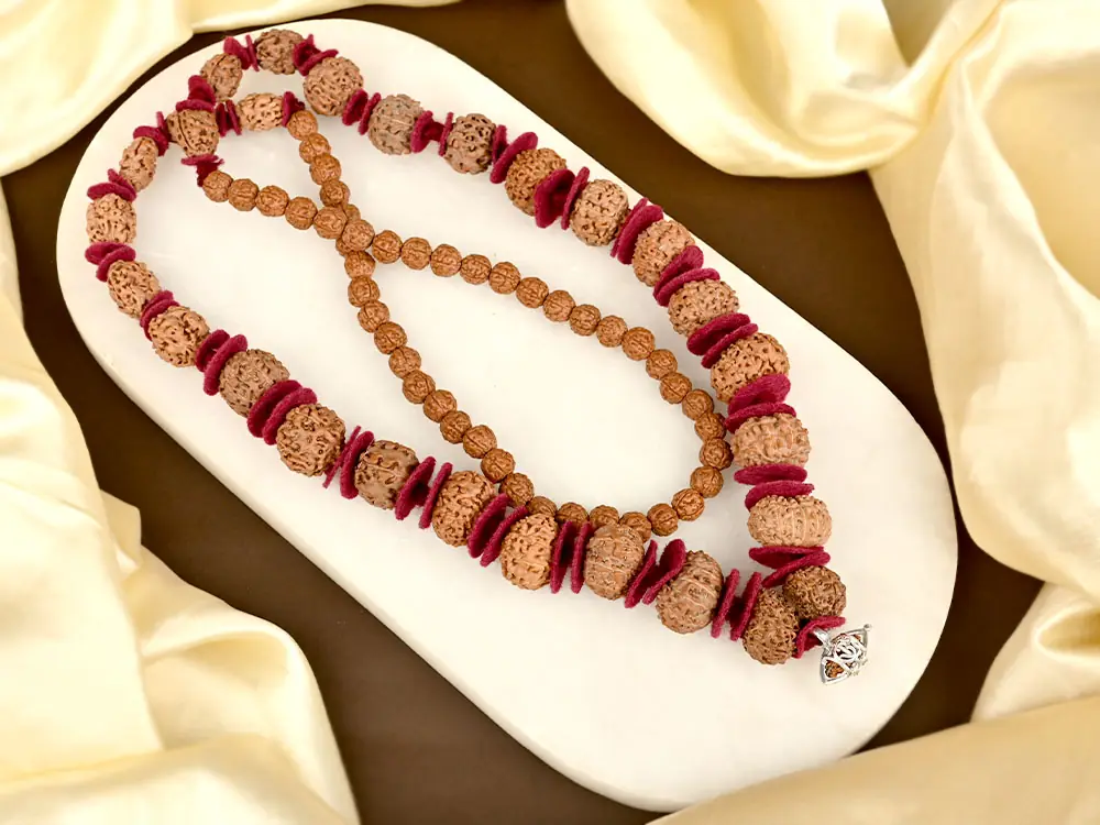 Siddha mala coiled on a white tray
